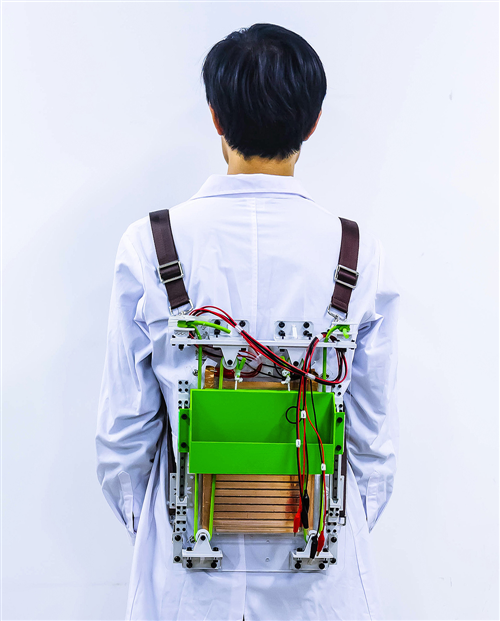 A prototype backpack harvests energy from walking to power small electronics, and it makes loads feel lighter. Credit: Adapted from ACS Nano 2021, DOI: 10.1021/acsnano.0c07498